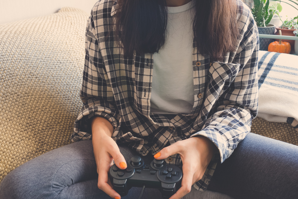 Female gamer playing video games.
